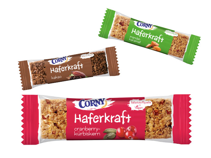 Corny Haferkraft in drei leckeren Sorten Kakao, Cranberry-Kürbiskern, Mandel-Karamell und Kakao